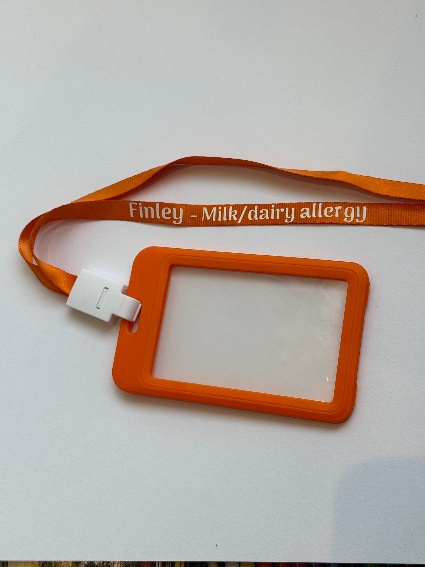 Orange lanyard with a card holder on a white background