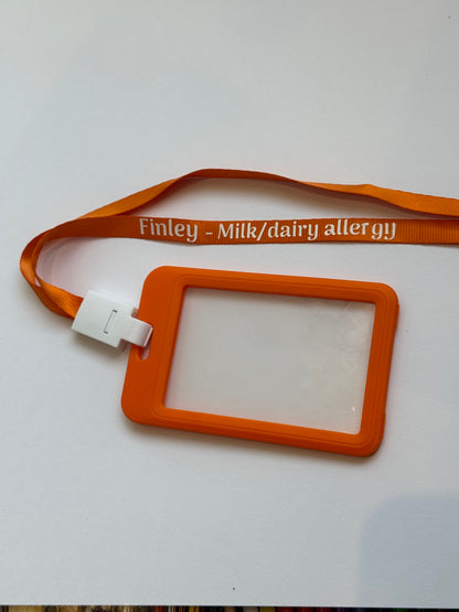 Orange lanyard with a card holder on a white background