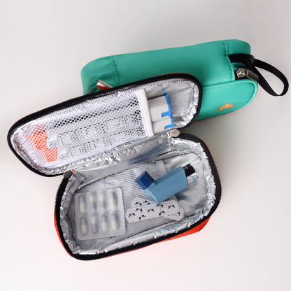 Open teal first aid kit with medical supplies on a white background