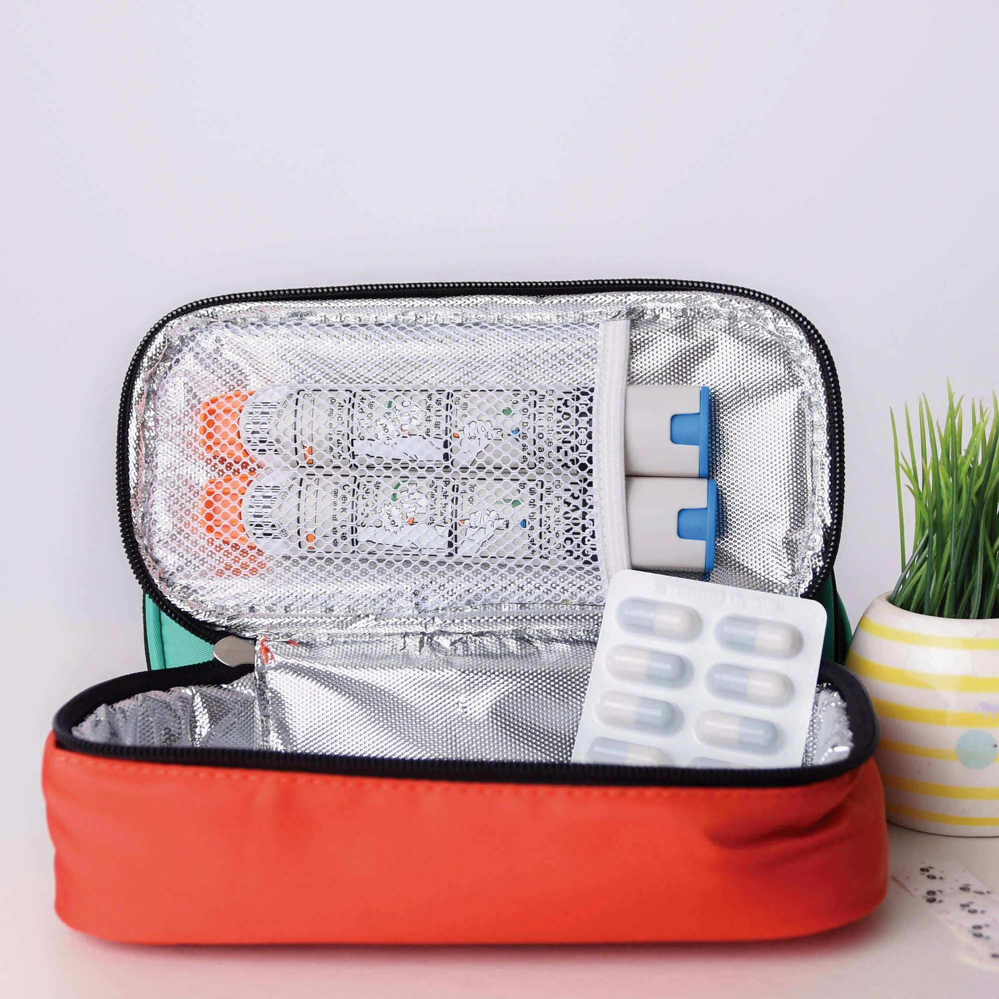 Open allergy travel pouch with medical supplies on a light background